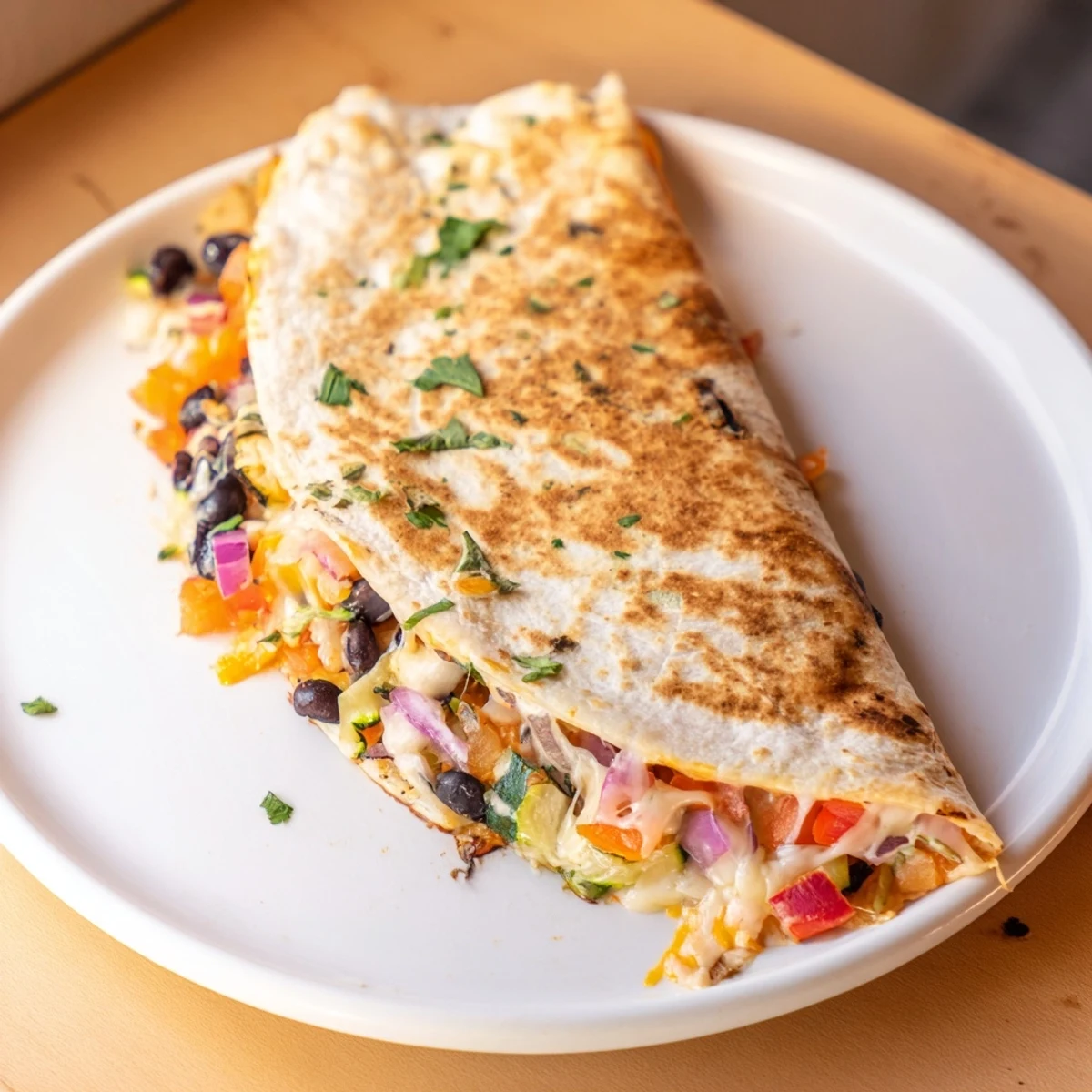 A close-up of delicious Vegetarian Quesadillas; beans and cheese overflowing from a crispy tortilla.