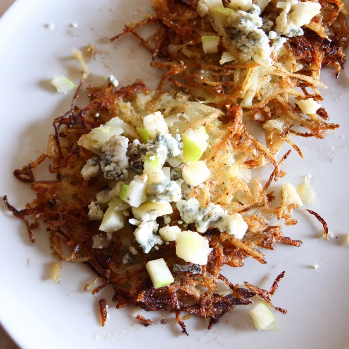 Crispy potato pancakes with tart Gorgonzola-apple compote, a budget-friendly and flavorful main dish.