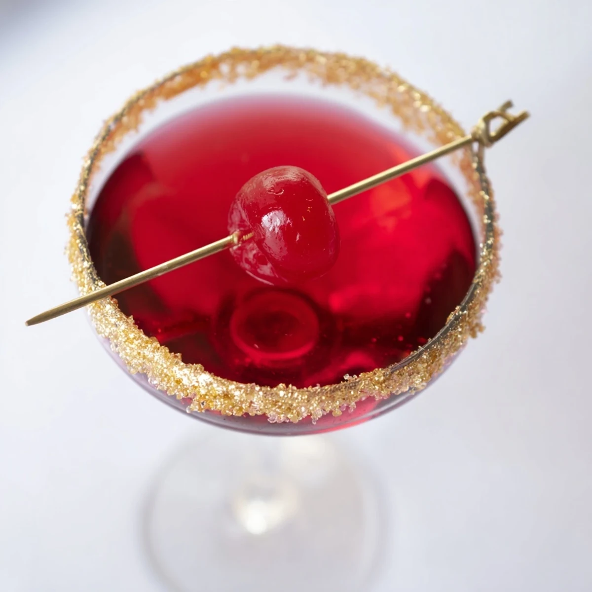Elegant Rococo Kirsch Martini, expertly shaken with a gold-sugared rim in a chilled glass.