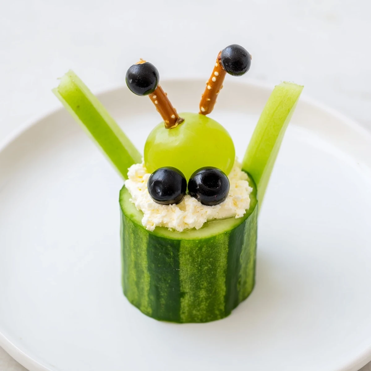 Vibrant photo: Little Green Men Alien Snack Attack, featuring fresh cucumber alien faces ready to be devoured at a party.