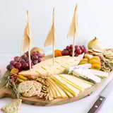 Elegant Sailboat Cheese Platter appetizer featuring a variety of cheeses, crackers, and nuts.