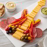 Savory Rock Star Guitar Snack Platter, showcasing cheese, meats, veggies, crackers, and dips arranged artfully.