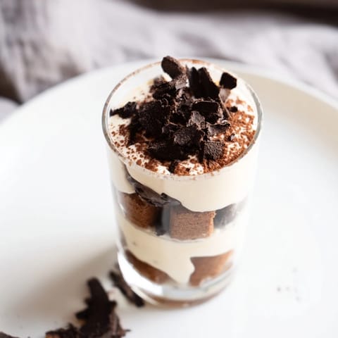 Deconstructed Tiramisu shots: Beautifully layered view, showcasing the rich espresso biscuits and airy mascarpone cream.