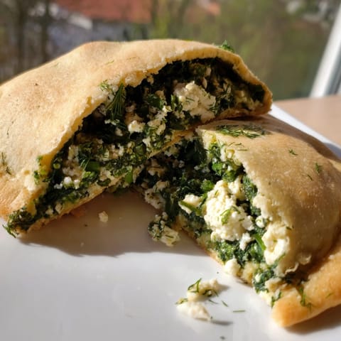 Golden, warm Turkish Spinach & Feta Flatbread, sizzling from the pan, ready to be sliced and enjoyed.